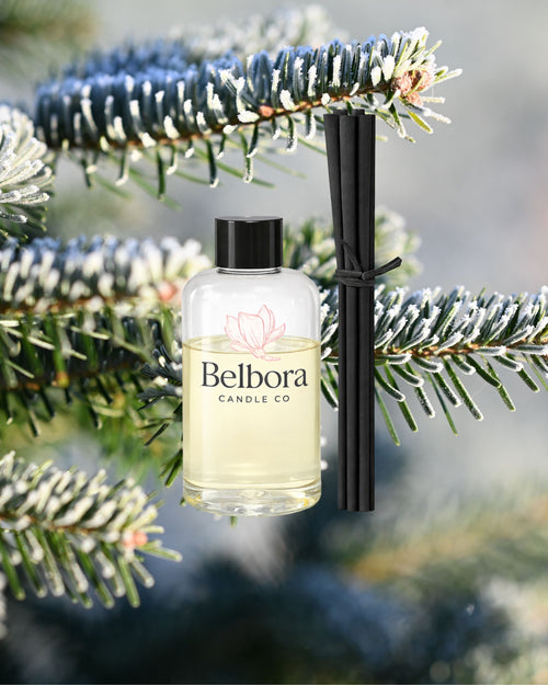 Bellora candle Co Barrington Tops Reed diffuser refill with a blurred pine background