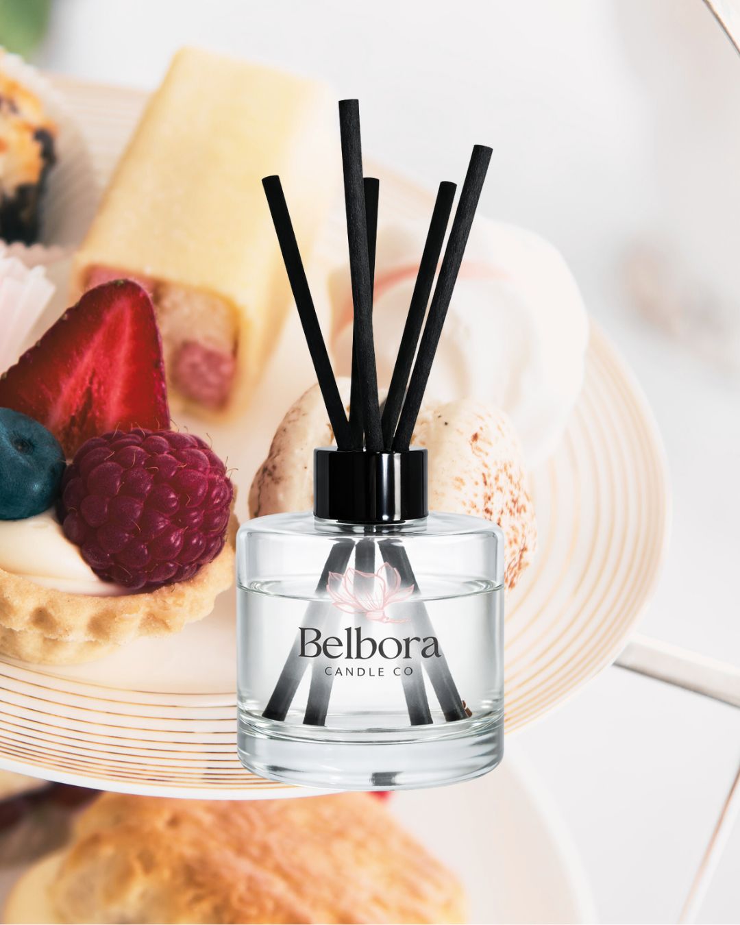 Belbora Candle Co Afternoon Tea Reed diffuser bottle with black sticks on a blurred dessert background