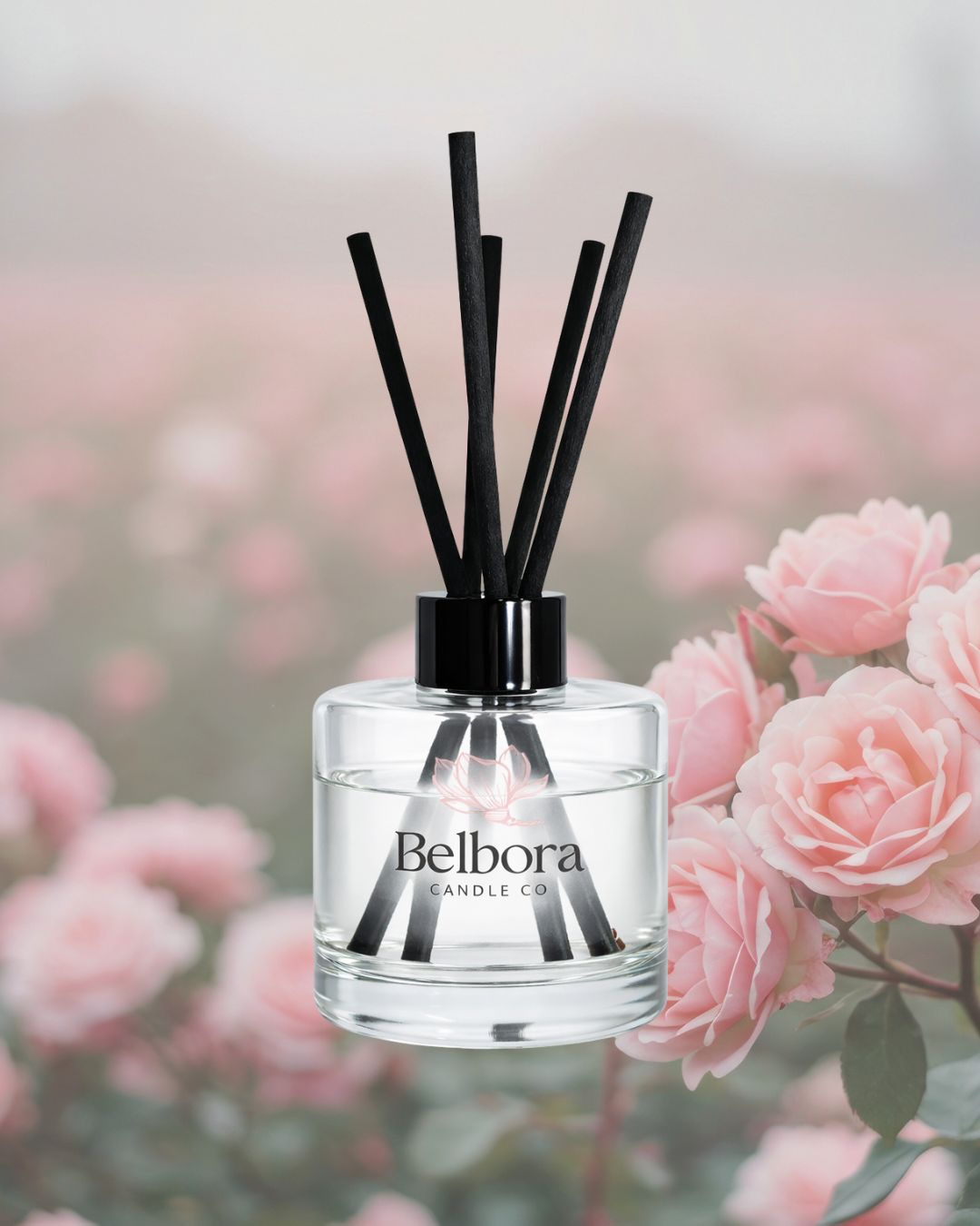 Belbora candle co Under the stars reed diffuser with black sticks against a blurred floral background