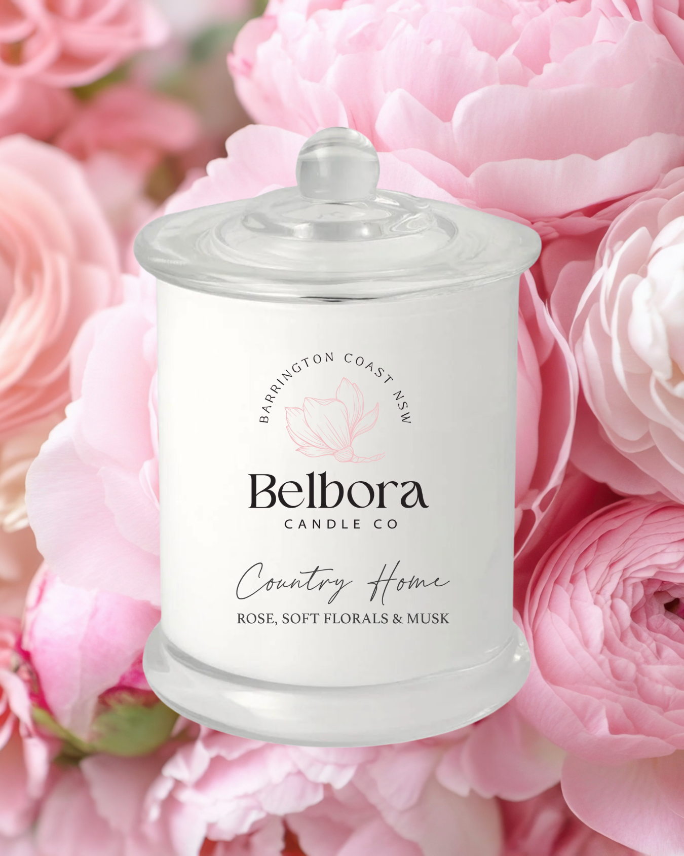 Belbora Candle Co. jar with 'Country Home' fragrance soy candle on a pink floral background.